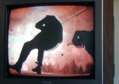 A man blown backwards by an explosive charge.