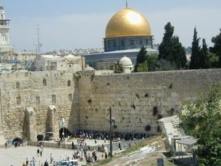 The Dome of the Rock above the Western Wall. To the right is the fenced path taken by Muslims on their way to worship. To understand the scale: the Temple was once much higher, before the sack by the Romans, and there are 17 unexcavated layers of stone below-ground.