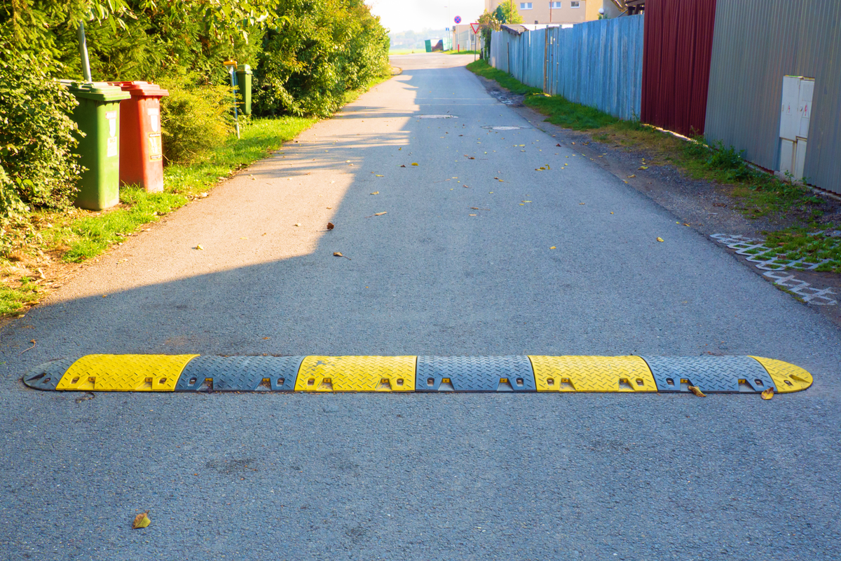 Image of a speedbump on a small road.