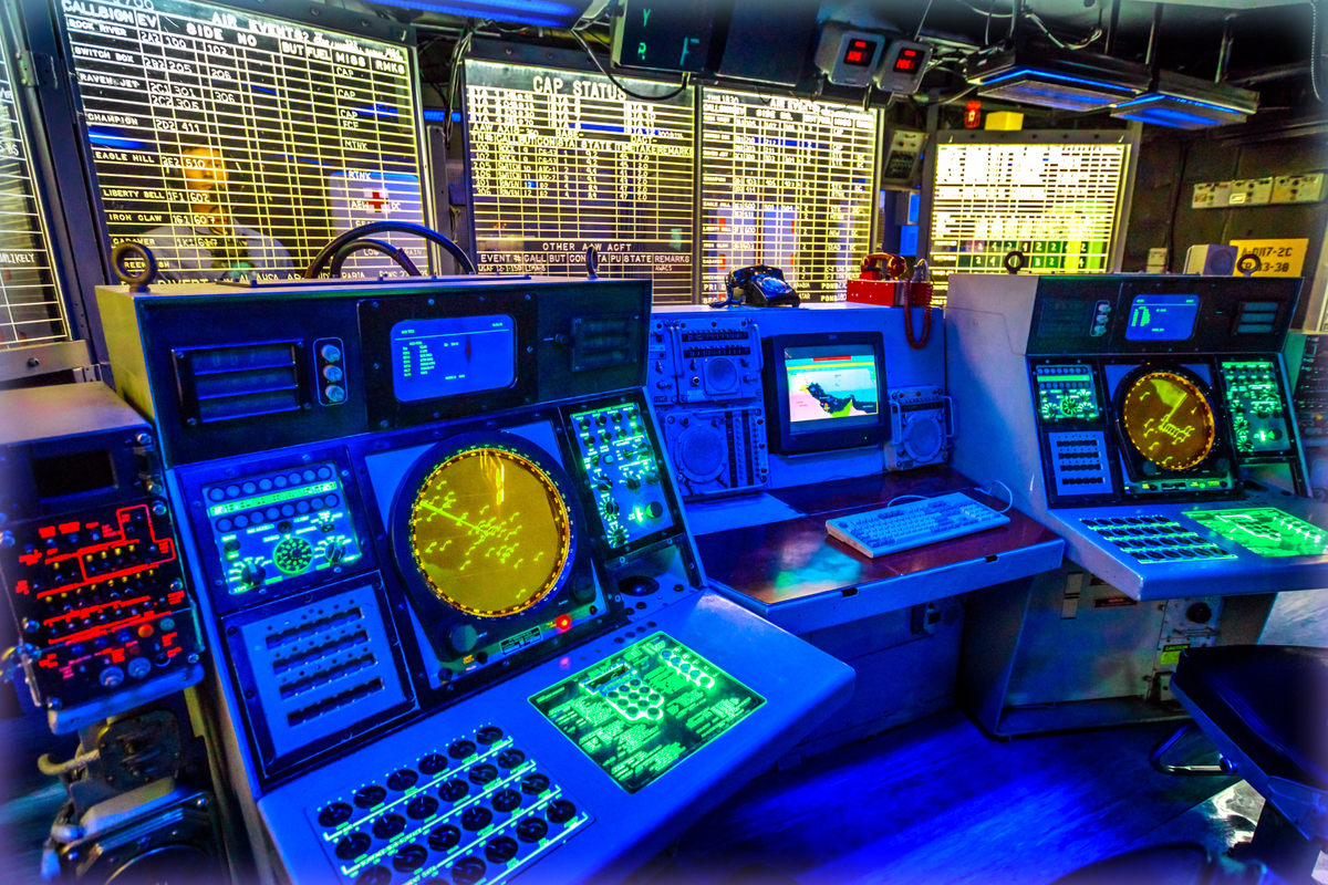 A combat information center radar console and maps of Battleship Midway at San Diego Navy Historic museum.