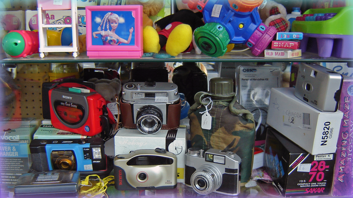 Image of a set of shelves in a thrift store with a hodgepodge of items.