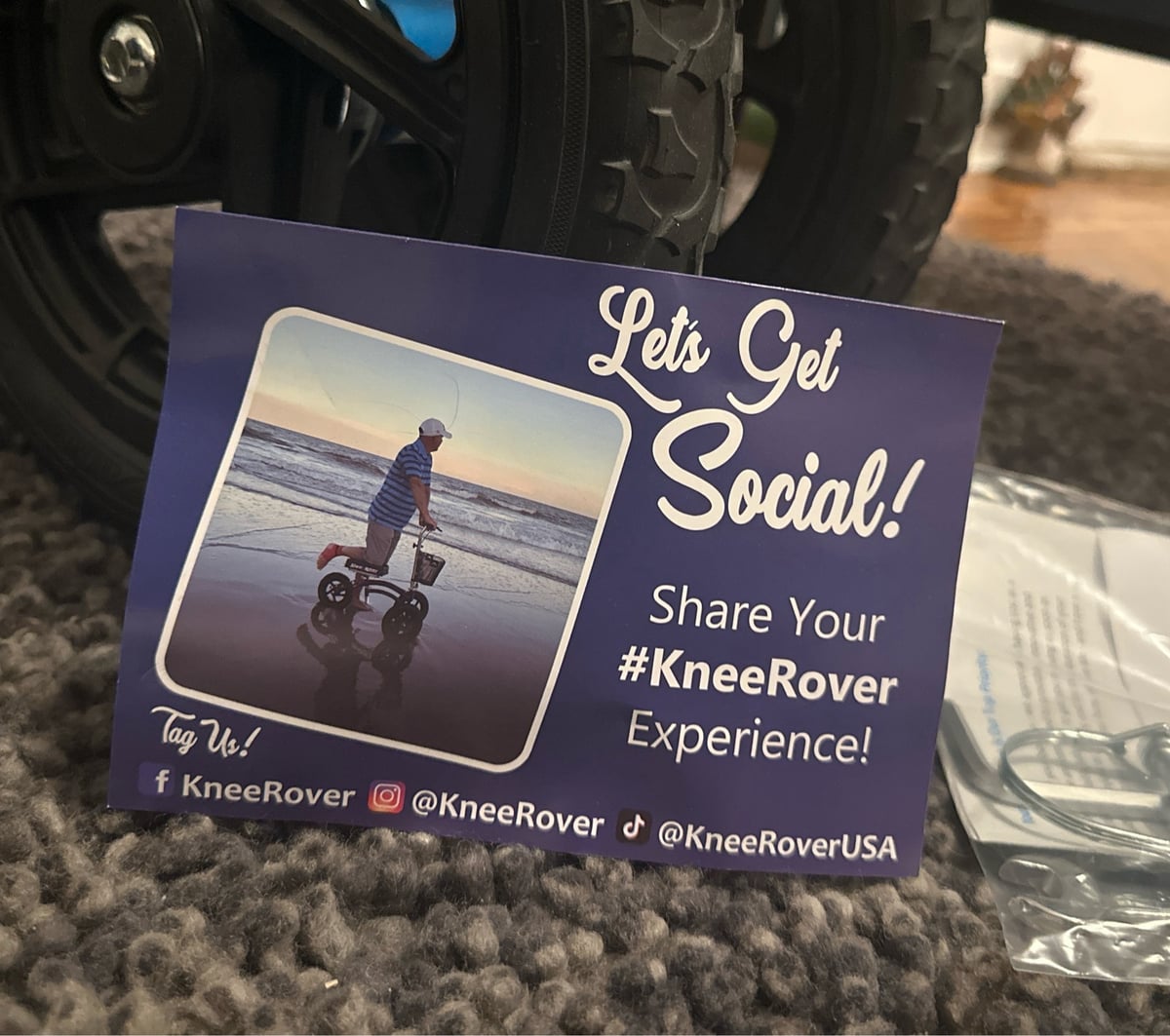 A postcard that says “Let’s get social! Share your KneeRover Experience!” With a picture of some dude knee rovin on the beach. Fml.