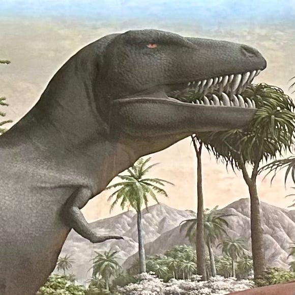 A t-rexish dinosaur with little tiny arms. Painted, part of a mural.