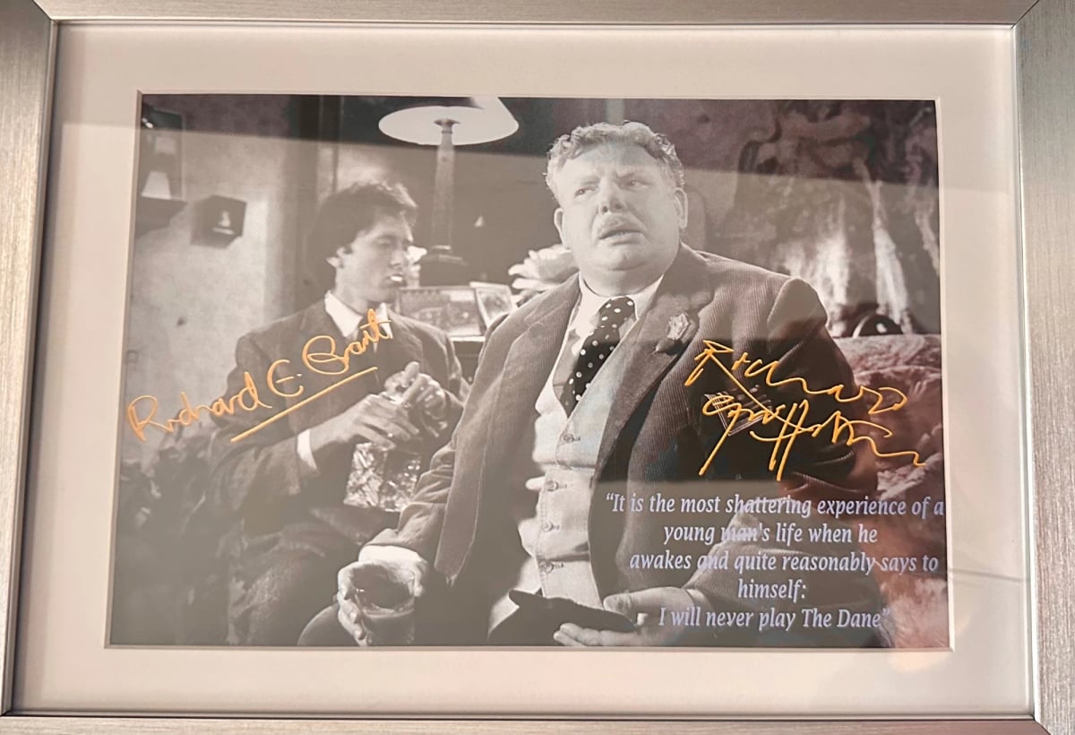 A black and white framed photo of Richard Grant and Richard Griffiths, signed in gold pen. A quote from Withal & I is printed atop Griffiths: "It's the most devastating moment in a young man's life, when he quite reasonably says to himself, 'I shall never play The Dane!'"